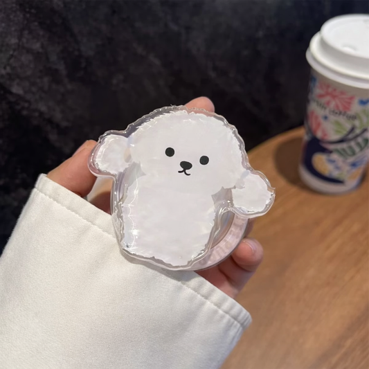 Hand holding a clear plastic bear-shaped container with a smiley face on a wooden surface.