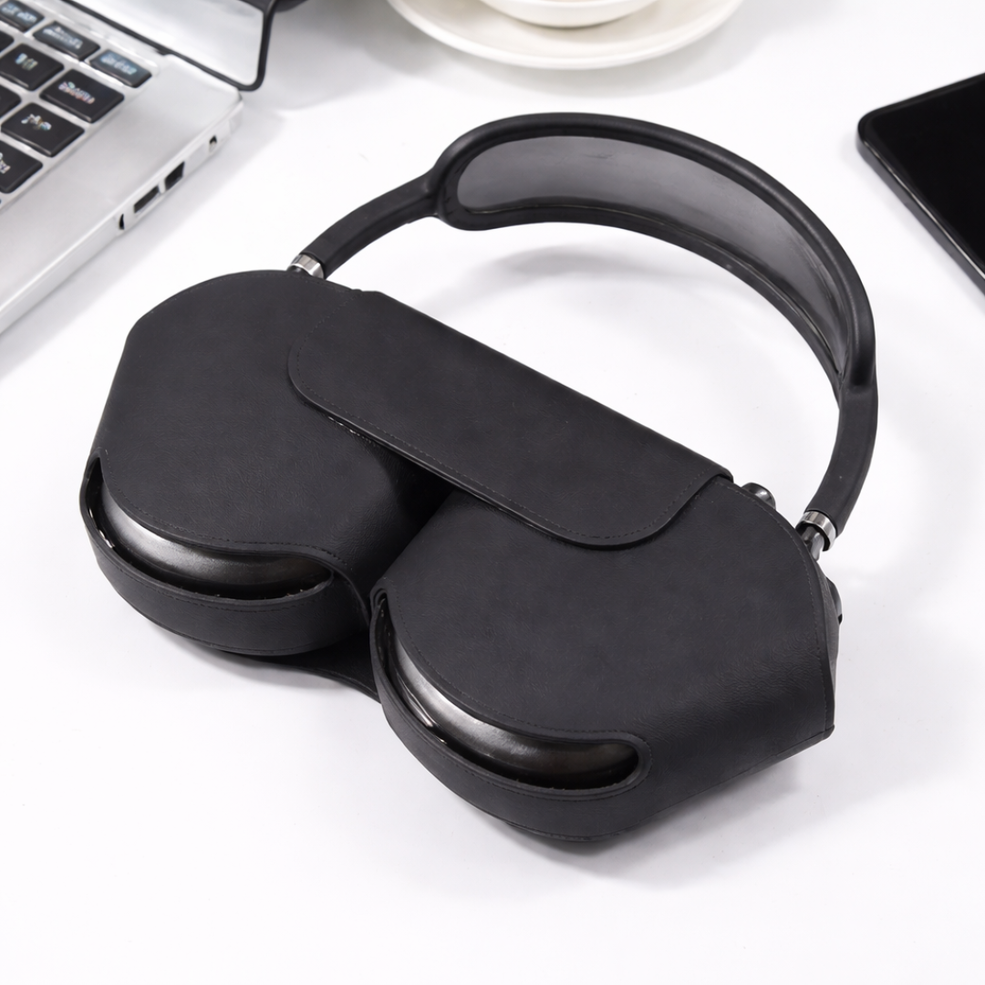 Black sleep mask on a white surface with a laptop in the background