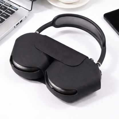 Black sleep mask on a white surface with a laptop in the background