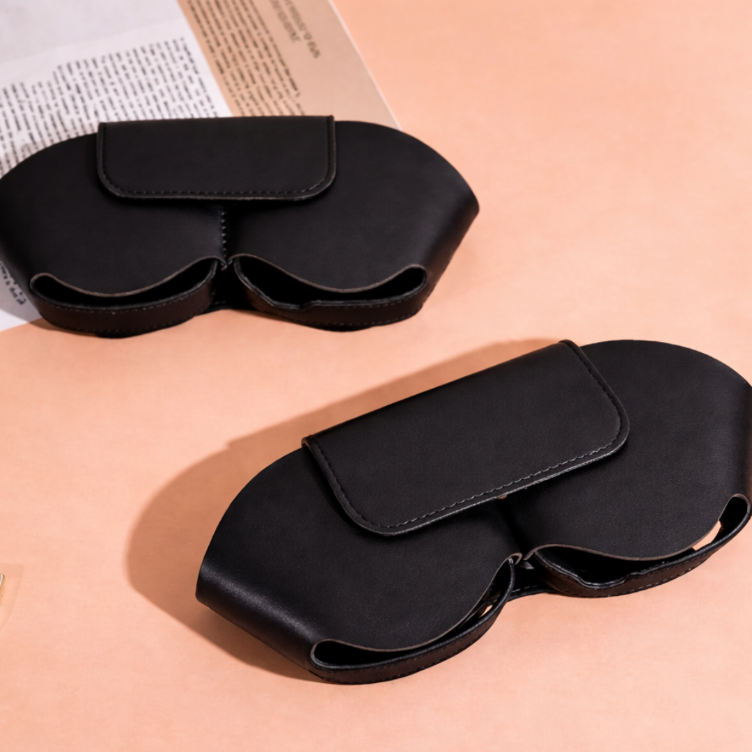 Black sleep mask on a peach background