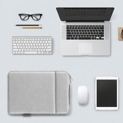 Laptop, keyboard, tablet, mouse, and glasses on a light gray surface