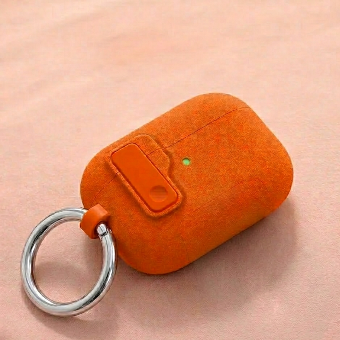 Orange case with a key ring on a pink background