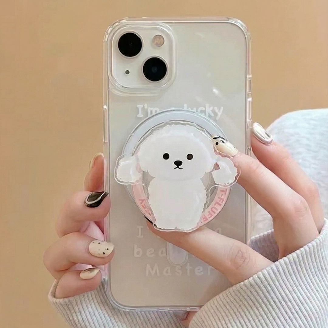 Phone case with a cute dog design held by a person against a beige background